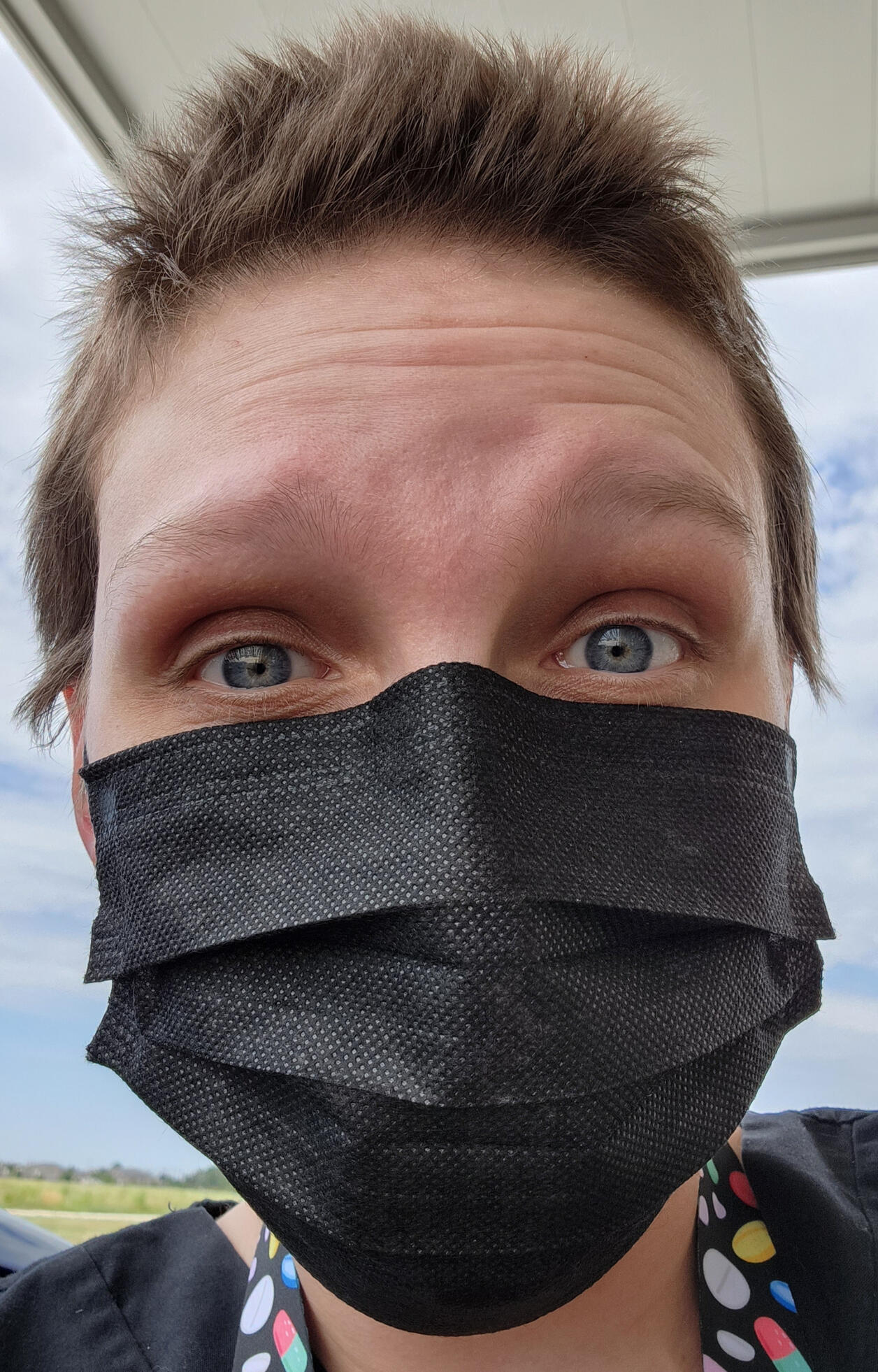 I am taking a selfie (in the classic pose with my arms stretched out in front of me) with my orange rescue cat looking up at my face